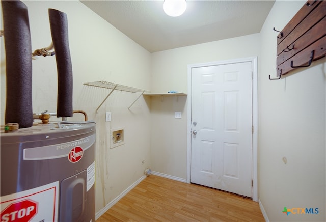 laundry room featuring electric water heater, hookup for a washing machine, and light wood-type flooring