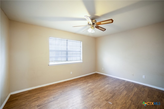 unfurnished room featuring ceiling fan and dark hardwood / wood-style floors