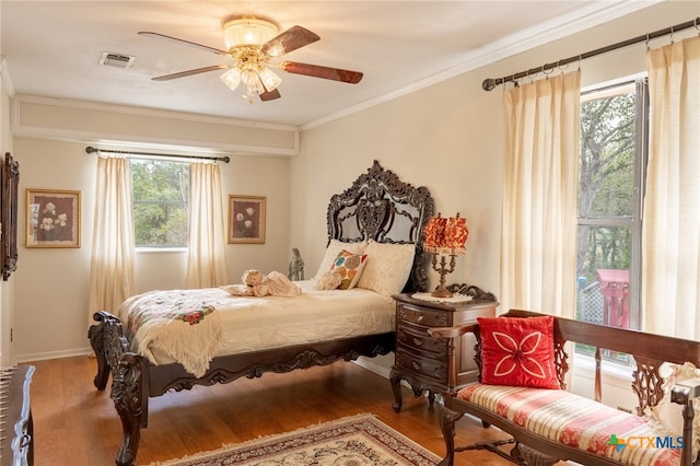 bedroom featuring ornamental molding, hardwood / wood-style floors, and ceiling fan