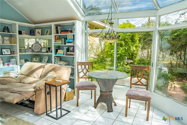 sunroom / solarium featuring vaulted ceiling