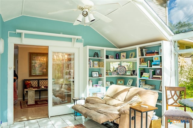 sitting room with lofted ceiling, light tile patterned flooring, and ceiling fan