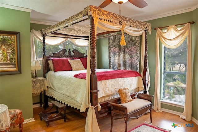 bedroom with wood-type flooring, ceiling fan, and crown molding