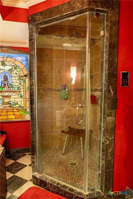 bathroom with a shower with door and ornamental molding