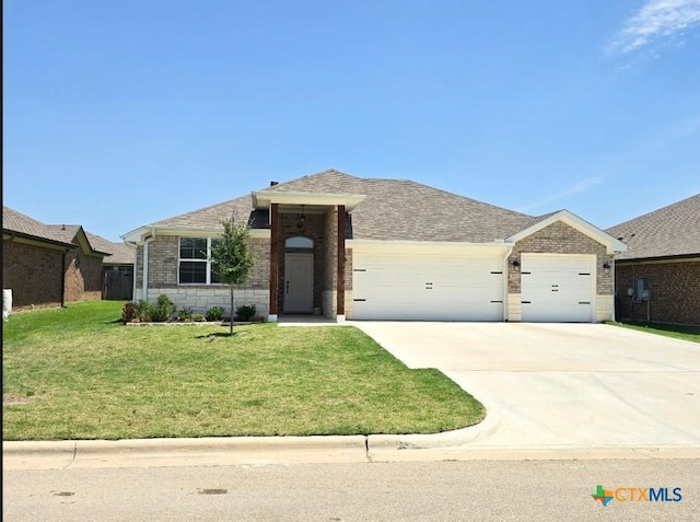 2635 Belle Hubbard Trl, Belton, TX 76513 - single story home featuring an attached garage, brick siding, driveway, and a front lawn