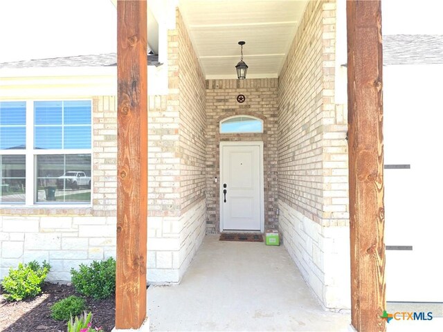 2635 Belle Hubbard Trl, Belton, TX 76513 - view of exterior entry with brick siding, a porch, and stone siding
