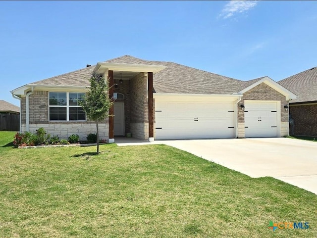 2635 Belle Hubbard Trl, Belton, TX 76513 - single story home featuring an attached garage, driveway, a front lawn, stone siding, and a shingled roof