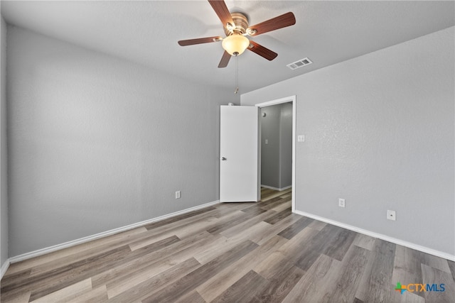 empty room with light wood-type flooring and ceiling fan