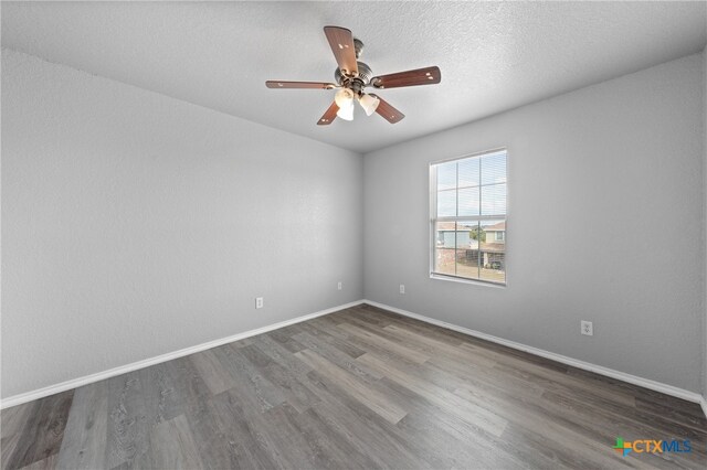 unfurnished room with hardwood / wood-style floors, ceiling fan, and a textured ceiling