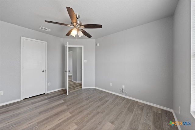 unfurnished bedroom featuring ceiling fan and light hardwood / wood-style flooring