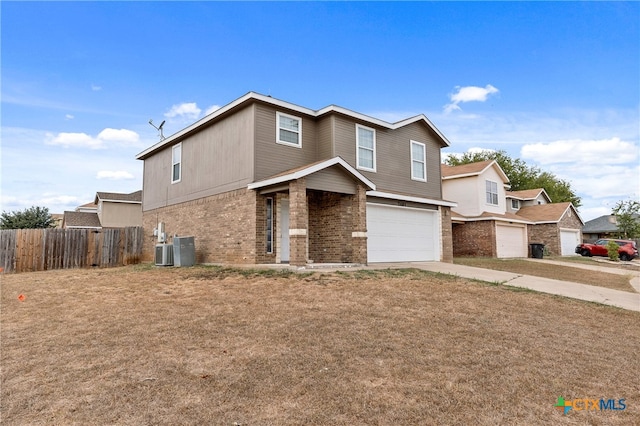 view of front property with a garage and central AC unit