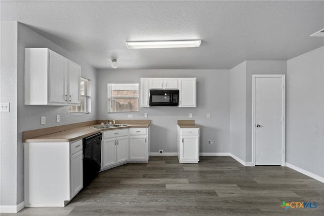 kitchen featuring dark hardwood / wood-style floors, white cabinetry, sink, and black appliances