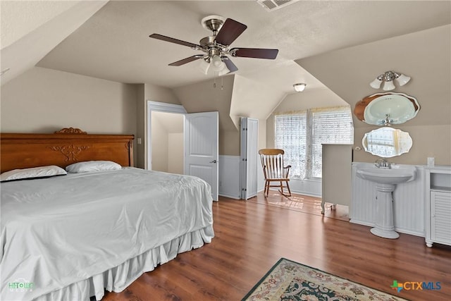 bedroom featuring wood finished floors, a ceiling fan, and vaulted ceiling