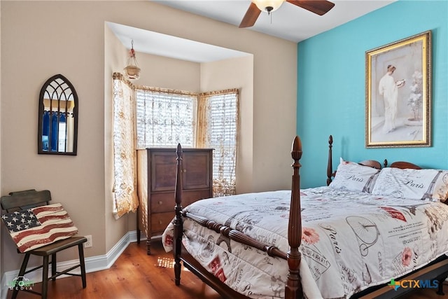 bedroom with baseboards and wood finished floors