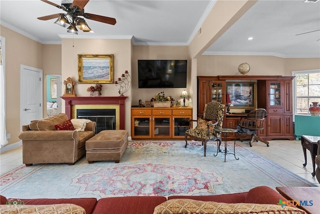 tiled living area featuring a glass covered fireplace, visible vents, a ceiling fan, and ornamental molding