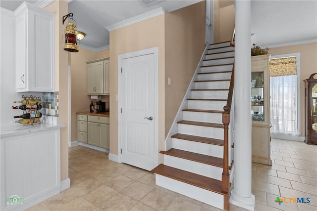 stairs featuring tile patterned flooring, baseboards, and ornamental molding