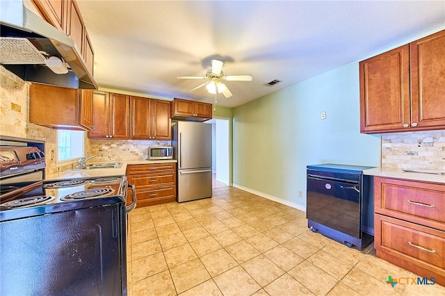 kitchen with appliances with stainless steel finishes, light tile patterned floors, ceiling fan, and decorative backsplash