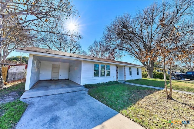 ranch-style house with a front lawn and a carport