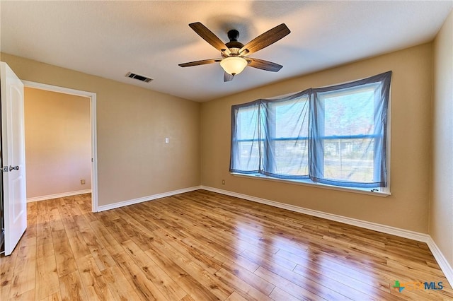 spare room with light hardwood / wood-style flooring and ceiling fan