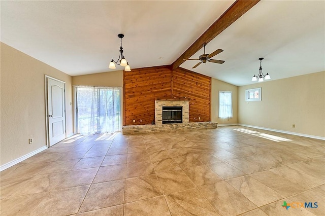 unfurnished living room with lofted ceiling with beams, ceiling fan, and wood walls