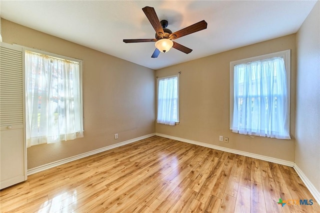 empty room with ceiling fan and light wood-type flooring