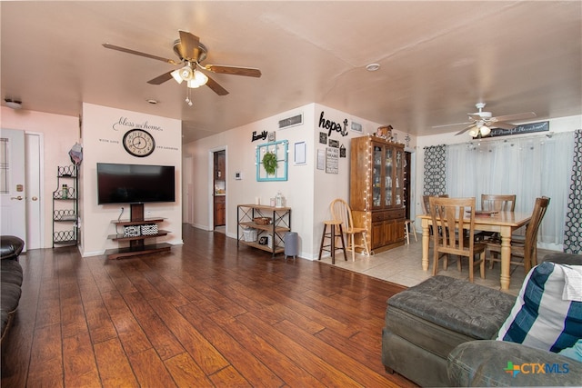 living room featuring hardwood / wood-style floors and ceiling fan