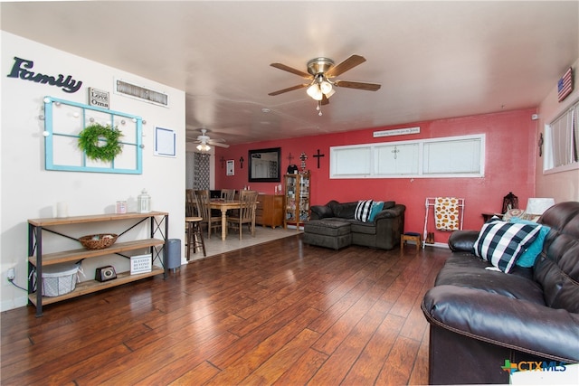 living room featuring hardwood / wood-style floors and ceiling fan