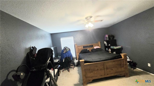 carpeted bedroom with a ceiling fan, a textured wall, a textured ceiling, and baseboards