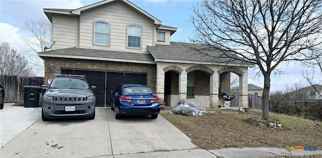 view of front facade with brick siding, roof with shingles, concrete driveway, fence, and a garage