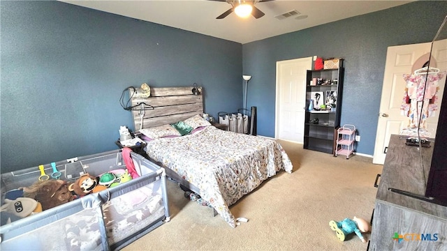 bedroom with carpet, visible vents, and a ceiling fan