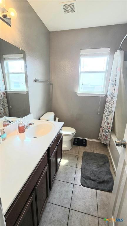 full bathroom with visible vents, baseboards, toilet, tile patterned flooring, and vanity