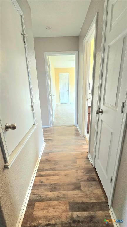 corridor with light wood-type flooring