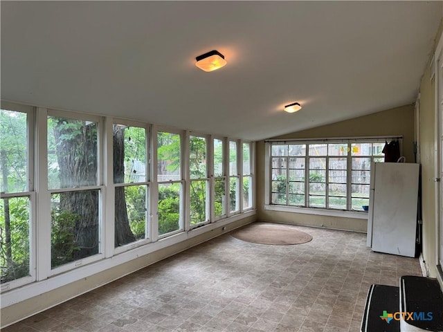 unfurnished sunroom featuring lofted ceiling