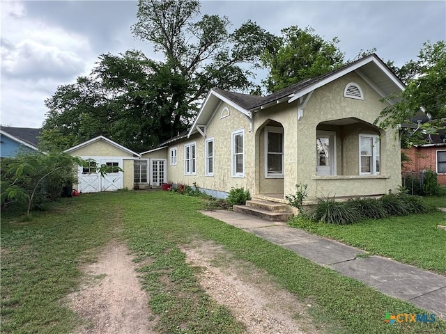 view of front of property with a front lawn and stucco siding