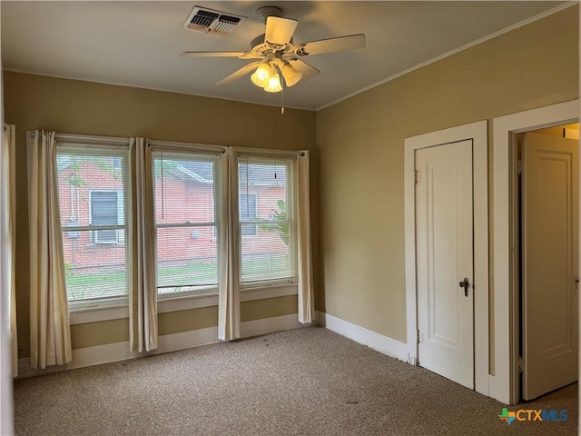 507 N Gonzales St, Cuero, TX 77954 - spare room with carpet floors, a ceiling fan, baseboards, and crown molding