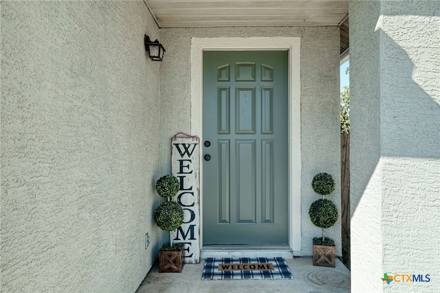 doorway to property with stucco siding