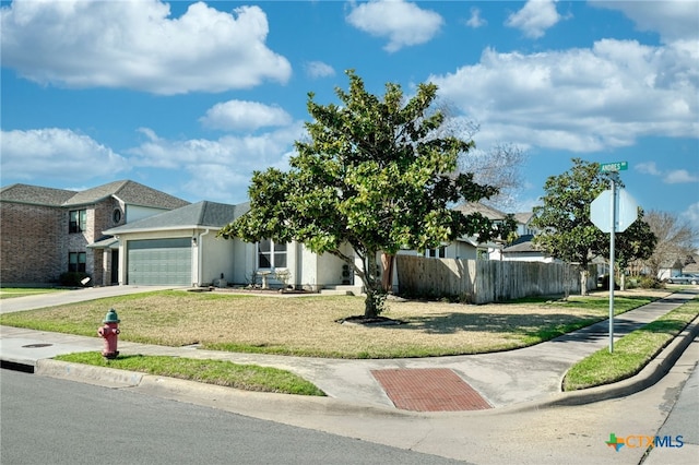 view of front of property featuring a garage and a front lawn