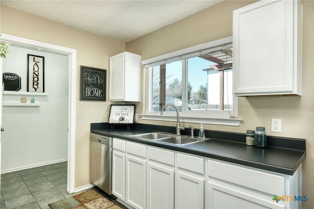 kitchen featuring a textured ceiling, dishwasher, white cabinetry, and sink