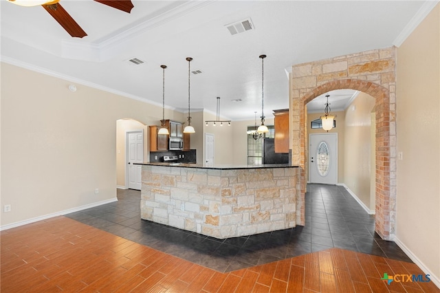 bar with dark hardwood / wood-style flooring, hanging light fixtures, and ornamental molding