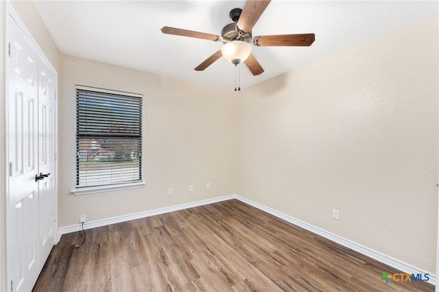 empty room featuring ceiling fan and wood-type flooring