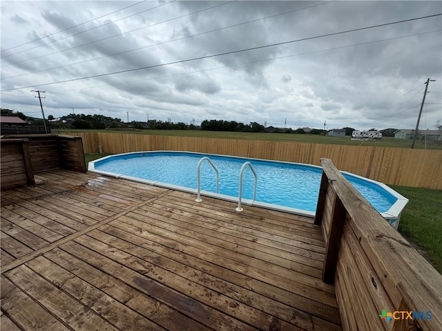 view of swimming pool featuring a deck