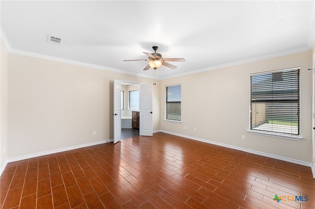 empty room with dark hardwood / wood-style flooring, ornamental molding, and ceiling fan