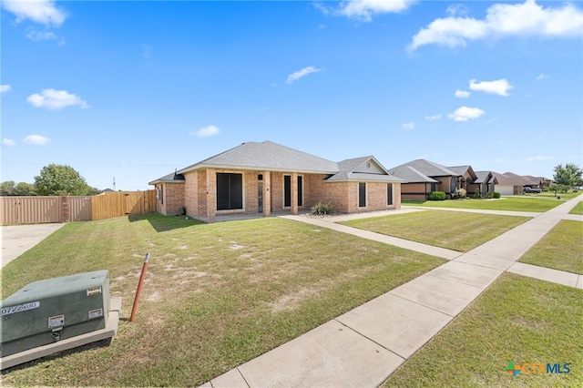 ranch-style home with a front yard and a garage