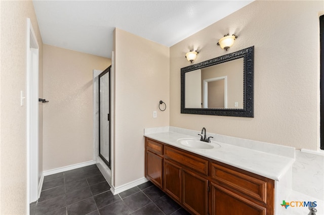 bathroom with vanity, a shower with door, and tile patterned flooring