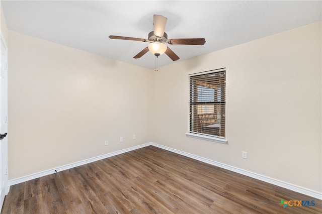 spare room featuring ceiling fan and dark hardwood / wood-style flooring