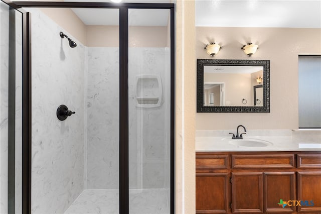 bathroom with walk in shower and vanity