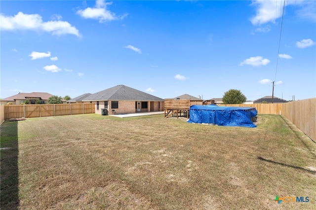 view of yard with a patio and a covered pool