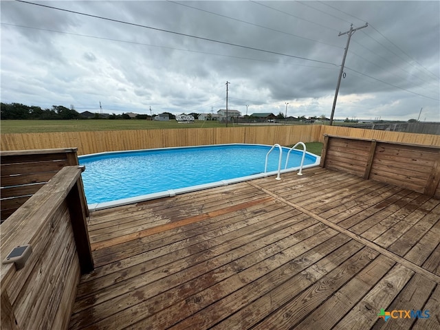 view of swimming pool with a wooden deck