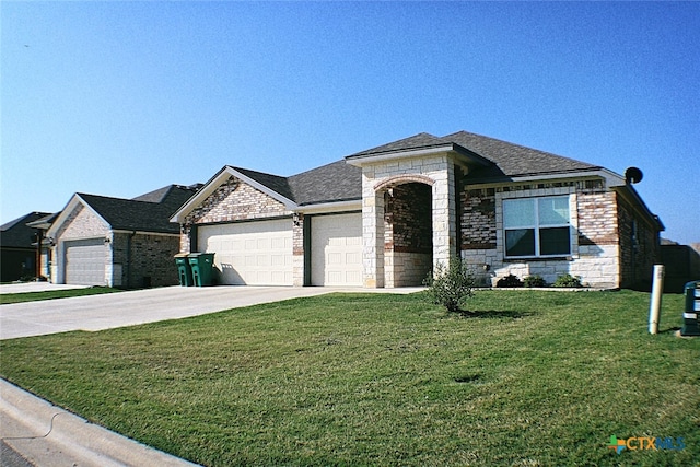 view of front of home featuring a garage and a front lawn