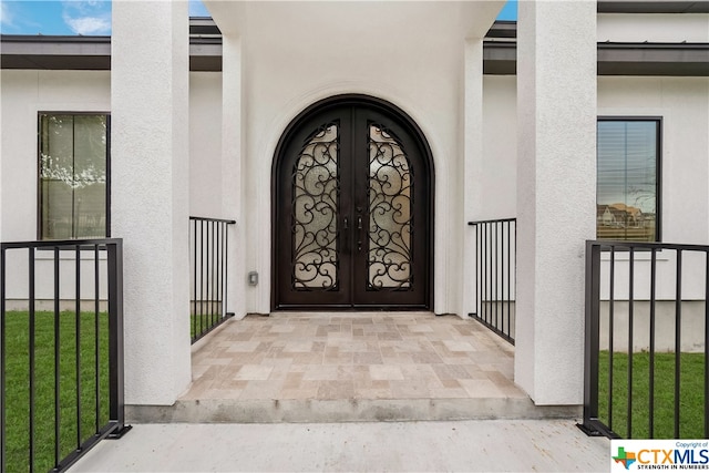 view of exterior entry featuring french doors