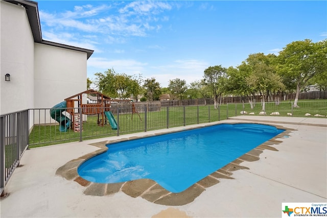 view of pool with a patio area, a playground, and a lawn